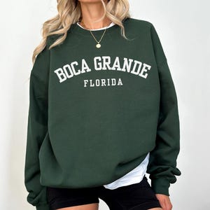 May include: A dark green sweatshirt with white text that reads "Boca Grande Florida".