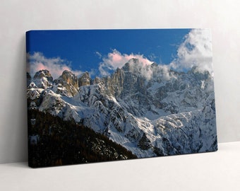 May include: A panoramic view of snow-capped mountains with a blue sky and white clouds. The mountains are covered in snow and ice, and the sky is a bright blue. The clouds are white and fluffy, and they are scattered across the sky.