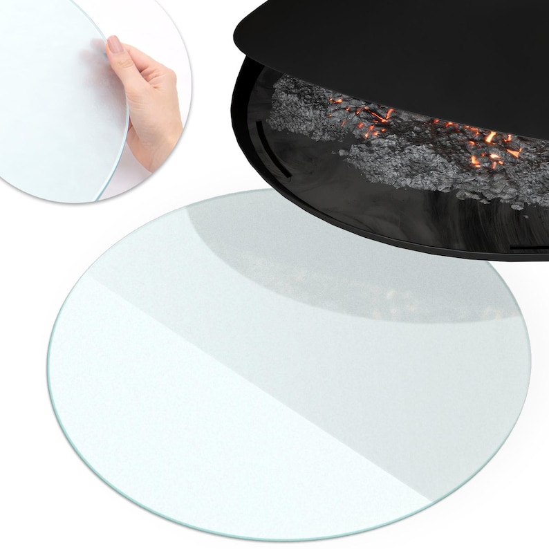 May include: A circular, clear glass plate with smooth, rounded edges. The glass is transparent and reflective, shown both as a standalone flat disc and in a circular inset view. The plate is positioned near a black, curved fireplace insert.