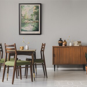 May include: A dining room with a wooden table and four chairs. The table has a green tablecloth and a vase of flowers. There is a framed print of a landscape on the wall. A wooden cabinet with sliding doors is in the background.