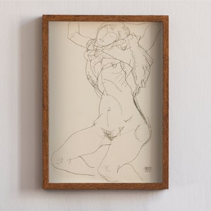 May include: A black and white line drawing of a nude figure in a standing pose, framed in a brown wood frame.
