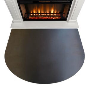 May include: A dark grey, semi-circular fireplace hearth rug is positioned in front of a white fireplace with a simulated fire. The rug is made of a solid material, offering floor protection. The fireplace has a width of approximately 100 cm.