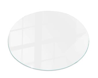 Puede incluir: Una mesa de vidrio redonda y transparente con un borde pulido. El vidrio refleja la luz, creando reflejos y sombras brillantes. La mesa tiene un diseño simple y moderno, adecuado para varios estilos de muebles.