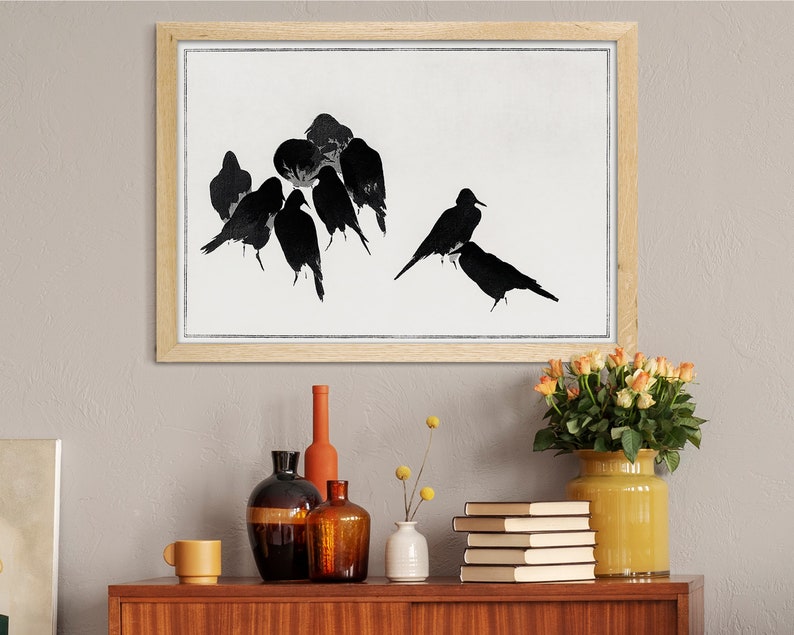 May include: A framed black and white print of a flock of birds in flight. The birds are silhouetted against a white background. The frame is made of light wood.