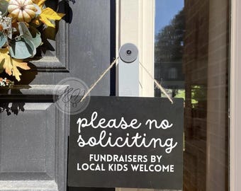 no soliciting sign, local fundraisers welcome for front door form of house