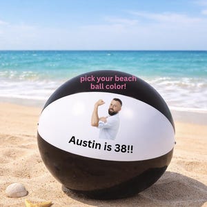 May include: A black and white beach ball with the text "Austin is 38!!" and "pick your beach ball color!" printed on it. The beach ball is on a sandy beach with a starfish and seashells.