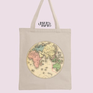 May include: A beige canvas tote bag with a vintage world map design printed on the front. The map is in shades of pink, yellow, green, and blue.