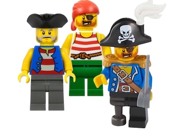 May include: Three Lego pirate minifigures. One figure wears a red and white striped shirt, a green sash, and a red bandana. Another figure wears a blue and white striped shirt, a blue jacket, and a black hat. The third figure wears a blue shirt, a black hat with a skull and crossbones, and a gold sash.