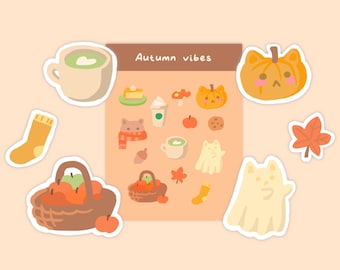 Può includere: Un foglio di adesivi a tema autunnale. Gli adesivi mostrano immagini di una zucca, un fantasma, una tazza di caffè, un cesto di mele, un calzino, una foglia d'acero e un gatto. Il foglio è intitolato "Vibrazioni autunnali".