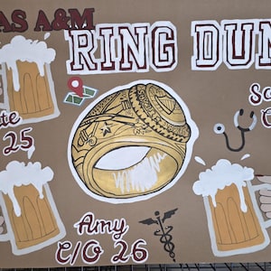 May include: A brown poster with the words "Texas A&M Ring Dunk" in maroon and white. The poster features a gold ring, beer mugs, and names with graduation years. A stethoscope and medical symbol are also included.