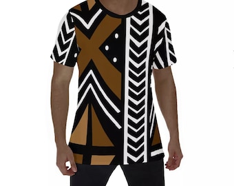 May include: A short-sleeved t-shirt with a geometric pattern in brown, black, and white. The design features chevron, triangle, and cross shapes. The shirt has a black crew neck and is likely made of a soft, breathable fabric.