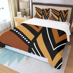 May include: A bed set with a duvet cover and two pillowcases. The bedding features a geometric pattern in shades of brown, black, and tan, with white accents. The design includes stripes, angles, and dotted lines, creating a modern aesthetic.