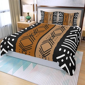 May include: A bed set featuring a duvet cover and two pillowcases with a geometric tribal pattern. The design includes black, brown, and white shapes and lines. The bedding is displayed on a bed with a neutral-toned headboard.
