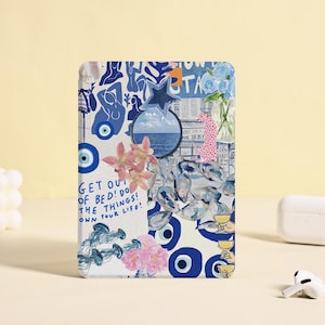 Pode incluir: Uma colagem de amuletos de olho turco azuis e brancos, flores e outros elementos decorativos sobre um fundo branco. O texto "GET OUT OF BED! DO THE THINGS! OWN YOUR LIFE!" está escrito com um marcador preto.