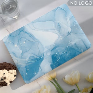 May include: A blue and white laptop skin with a marble-like design and gold glitter accents.  The design features abstract swirls and lines.