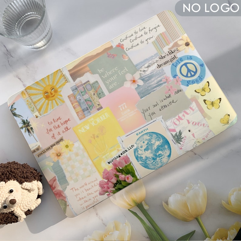 May include: A laptop with a colorful collage of stickers and images. The stickers include text like "to live for the hope of it all", "busting with life", "your soul is what makes you attractive", and "life is good".