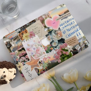 May include: A laptop skin featuring a collage of images, including flowers, stars, hearts, and text. The text includes "BE GENTLE WITH YOUR HEART", "FLEURS", "NOTHING CHANGES IF NOTHING CHANGES", and "Actually, life is beautiful and I have time."