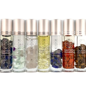 May include: Ten small glass bottles with silver caps filled with clear liquid and various colored crystals. The bottles are labeled "Earth's Elements".