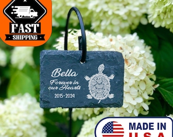 May include: Black slate garden marker with a turtle design and the text "Bella Forever in our hearts 2015-2024".