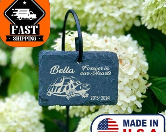 May include: Black slate garden stone memorial with a turtle silhouette and the text "Bella Forever in our Hearts 2015-2024".