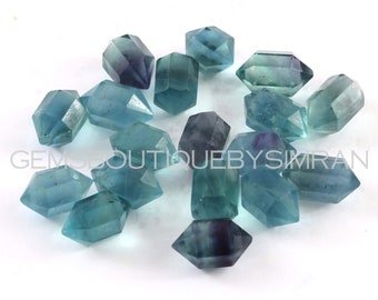 May include: A collection of 15 faceted, blue and green fluorite crystal points. The crystals are all approximately the same size and shape, and they have a smooth, polished finish.