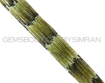 May include: A strand of green and black gemstone beads. The beads are round and have a smooth, polished finish. The strand is approximately 18 inches long.