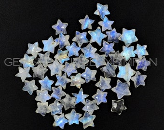 May include: A collection of 30 iridescent white moonstone star-shaped cabochons. The stones are approximately 10mm in size and have a smooth, polished finish.