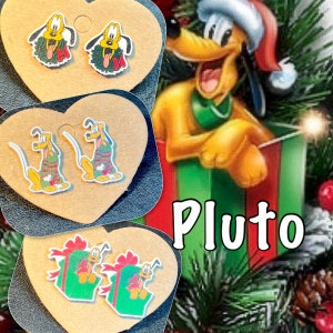 May include: A collection of Pluto-themed earrings. The earrings feature Pluto in various Christmas-themed designs, including a wreath, sweater, and gift box. The word "Pluto" is displayed in white text.