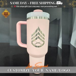 Close-up of a personalized 40oz powder-coated tumbler with a handle and straw. The laser engraving features a custom name in elegant script, a heart-shaped stethoscope design, and motivational nurse affirmations. The tumbler is shown in a professional setting, highlighting its durable finish and large capacity. Perfect gift for nurses and medical staff