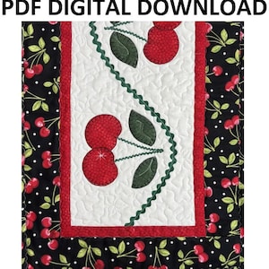 May include: A quilted table runner with a cherry design. The center panel is white with red cherries and green leaves. The border is black with white polka dots and cherry and leaf patterns. The text "PDF DIGITAL DOWNLOAD" is at the top.