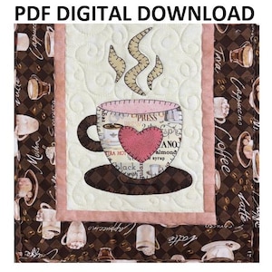 May include: A digital download pattern for a quilted coffee cup with a pink heart and steam. The cup is surrounded by a brown and white checkered border with coffee-themed text.