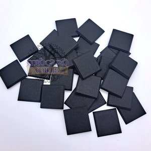 May include: A pile of 20 black square plastic bases for miniature figures. The bases are approximately 1 inch square.