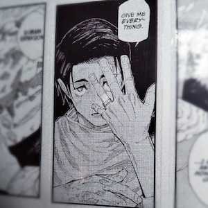 May include: A black and white manga panel sticker featuring a character with dark hair covering one eye with a hand wearing a ring. A speech bubble above the character contains the text, GIVE ME EVERYTHING. The art style uses detailed line work.
