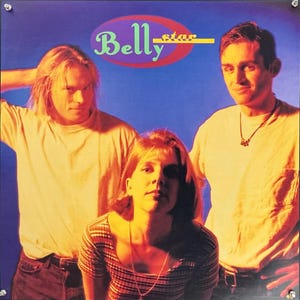 May include: A promotional poster featuring the band Belly. The band members are posed in front of a blue background. The band's name, "Belly", is displayed in a stylized font above the band members.