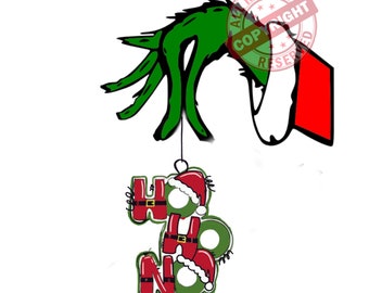 May include: A green Grinch hand holding a Christmas ornament that says "HO HO NO" in red and green letters with Santa Claus figures.