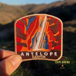 May include: An embroidered patch featuring a colorful illustration of Antelope Canyon, with the text "Antelope Canyon" below. The patch is brown with orange, red, and blue accents. The patch is part of the "Endless Explorers Club".