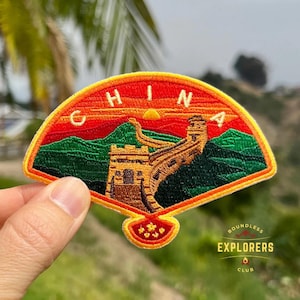 Peut inclure: Écusson brodé en forme d'éventail représentant la Grande Muraille de Chine sous un coucher de soleil. Le mot "CHINA" est brodé en haut. Le texte "BOUNDLESS EXPLORERS CLUB" est également présent.