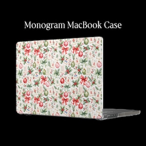 May include: A MacBook case featuring a festive pattern of mahjong tiles, red and green Christmas ornaments, pine branches, holly berries, and red bows. The text Monogram MacBook Case is displayed above the laptop on a solid black background.