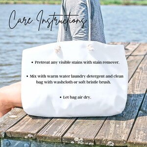 May include: A white tote bag with rope handles, held by a person. The bag has the words "Care Instructions" in cursive script at the top. Instructions include stain removal, washing with detergent, and air drying.