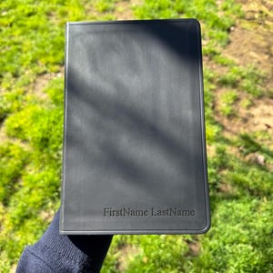 May include: A set of three ceramic mugs with a speckled, matte finish. The mugs are in shades of cream, light gray, and dark gray. Each mug has a simple, modern design and a rounded handle. The mugs are stacked on top of each other.