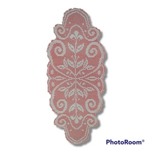 May include: White crocheted table runner with a floral design on a red background.