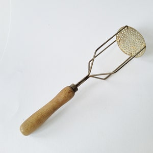 Ancient masher, for potatoes, puree, apple sauce, mash, masher, kitchen utensil, with wooden handle and patina, brocante decoration kitchen