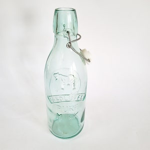 Old milk bottle with cow, swing top, pop top, green glass with cow motif, pressed glass, unused, from warehouse liquidation, pop bottle