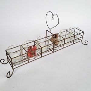 May include: A white ceramic mug with a black handle and the text "But First, Coffee" in a black, bold font. The mug is on a white surface. The mug is approximately 4 inches tall.