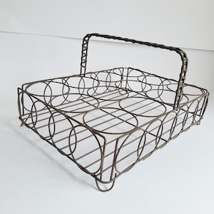 May include: A rectangular dark brown wire bottle carrier featuring a grid of six circular compartments for holding bottles. The carrier is constructed from thin metal wire with a single arched handle wrapped in a matching dark brown material.