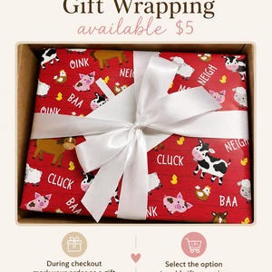 May include: A rectangular box wrapped in red paper featuring a pattern of farm animals including cows, pigs, sheep, horses, and chickens, with the text OINK, NEIGH, BAA, and CLUCK. A white satin ribbon is tied in a bow across the center of the box.