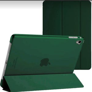 May include: A dark green tablet case and cover. The tablet is angled, revealing the Apple logo. The case is designed for device protection and has a sleek, modern look. The cover is folded back, acting as a stand for the tablet.