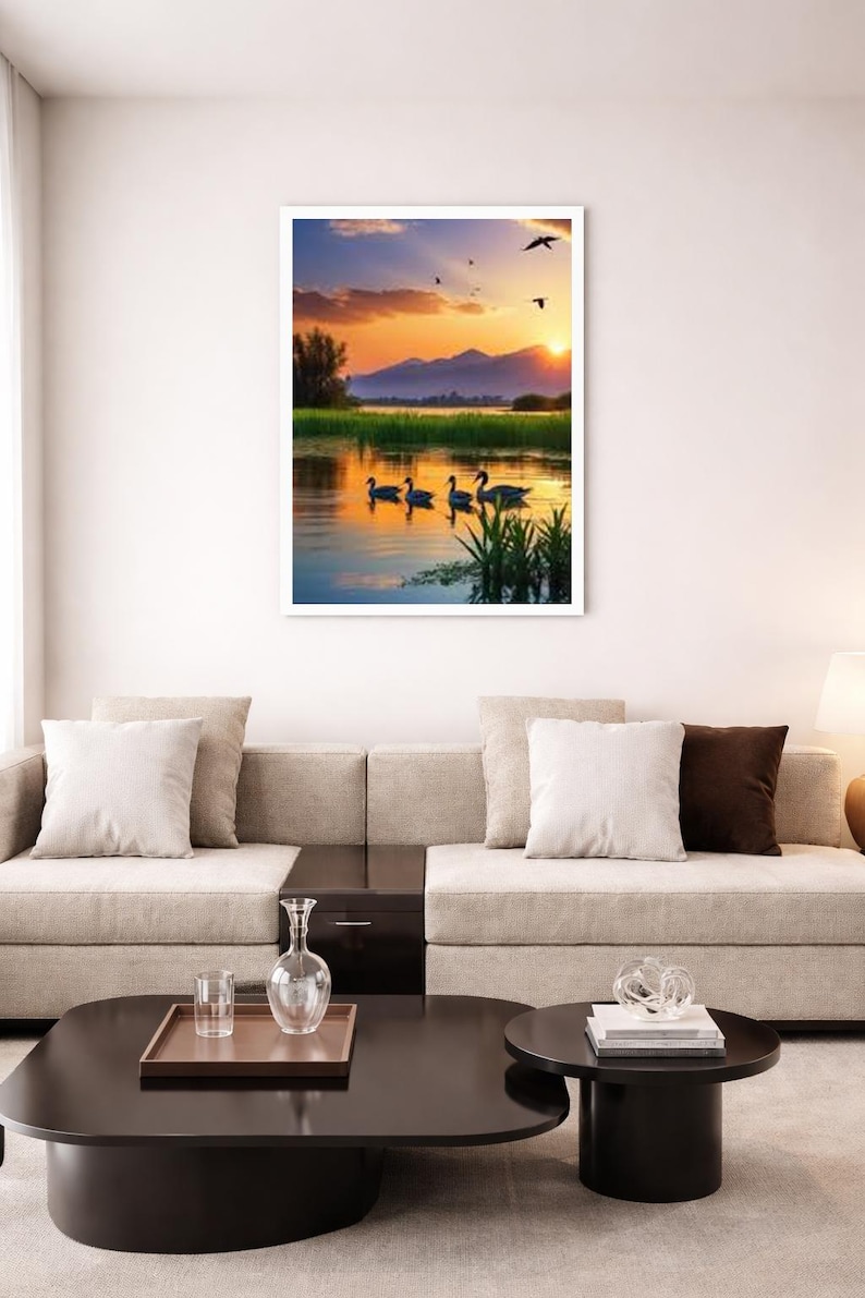 May include: A framed wall art print featuring a sunset landscape with four ducks swimming in a calm lake. The scene includes green reeds in the foreground, distant mountains, and a golden sky with birds flying above the water surface.