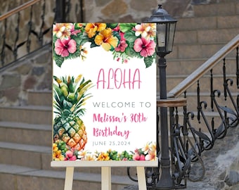 May include: A white sign with a tropical theme featuring a pineapple, flowers, and the text "Aloha, Welcome to Melissa's 30th Birthday, June 25, 2024". The sign is on a white easel.
