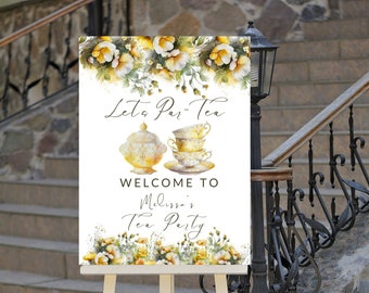 May include: A white sign with a floral border and the text "Let's Par-Tea" in gold lettering. The sign also features a teapot and teacups in watercolor style. The text "Welcome to Melissa's Tea Party" is also included in gold lettering.